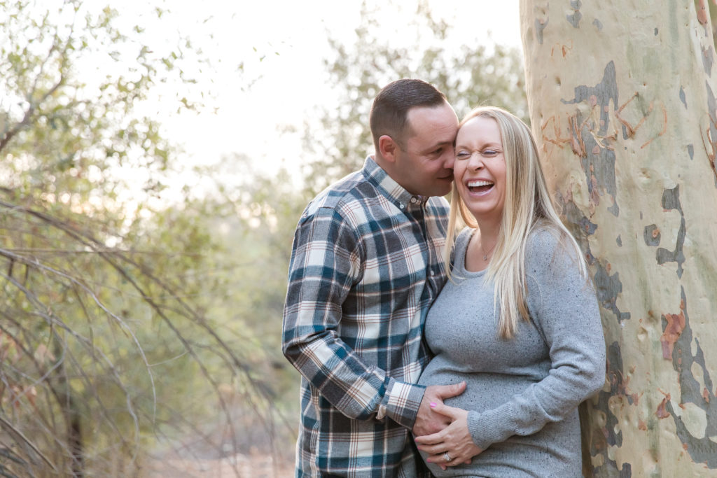 Dad to be whispering to Mom She is giggling