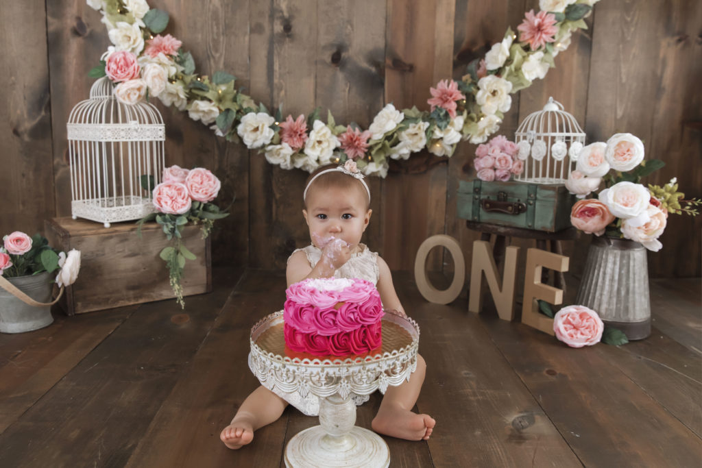 Baby with first birthday cake