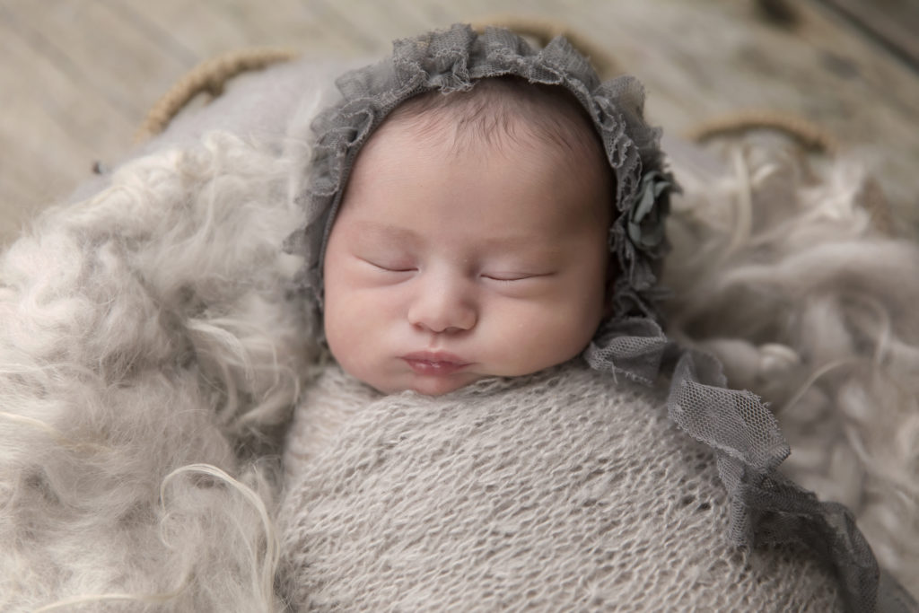 Newborn baby girl in bonnet