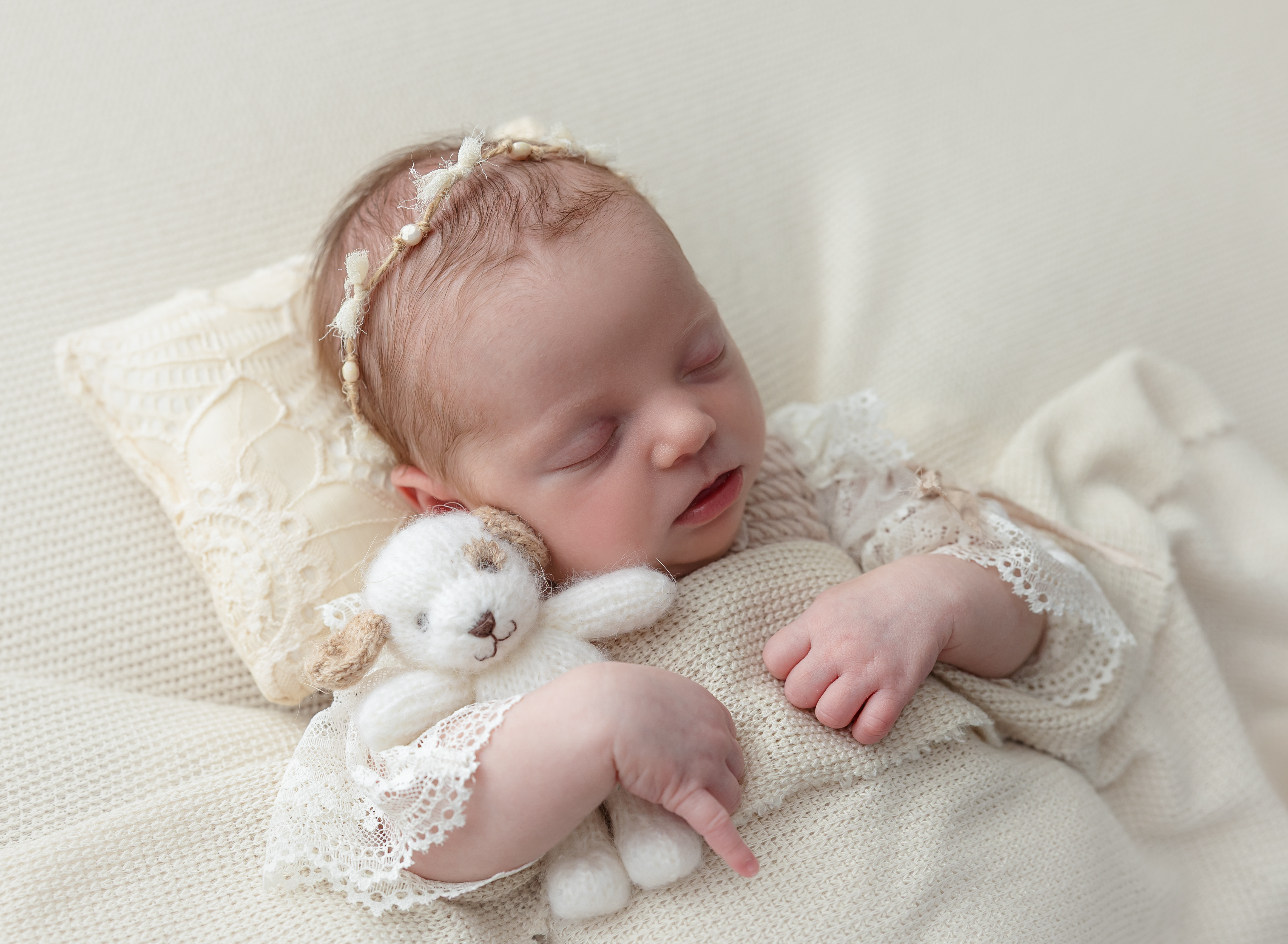 waco newborn sleeping with stuffed puppy 