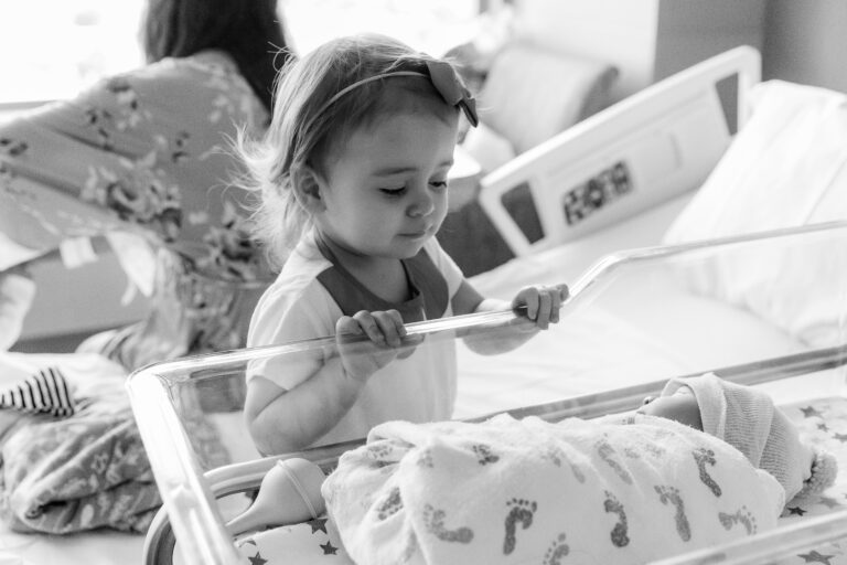 Waco Newborn photographer big sister looking at baby